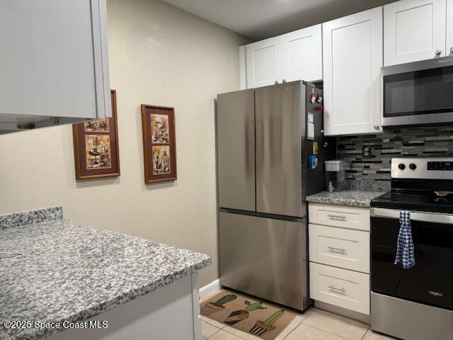 2727 North Wickham Road, Unit 20510 Melbourne, FL 32935 - Photo 2 of 25 a kitchen with stainless steel appliances granite countertop a refrigerator and a stove top oven