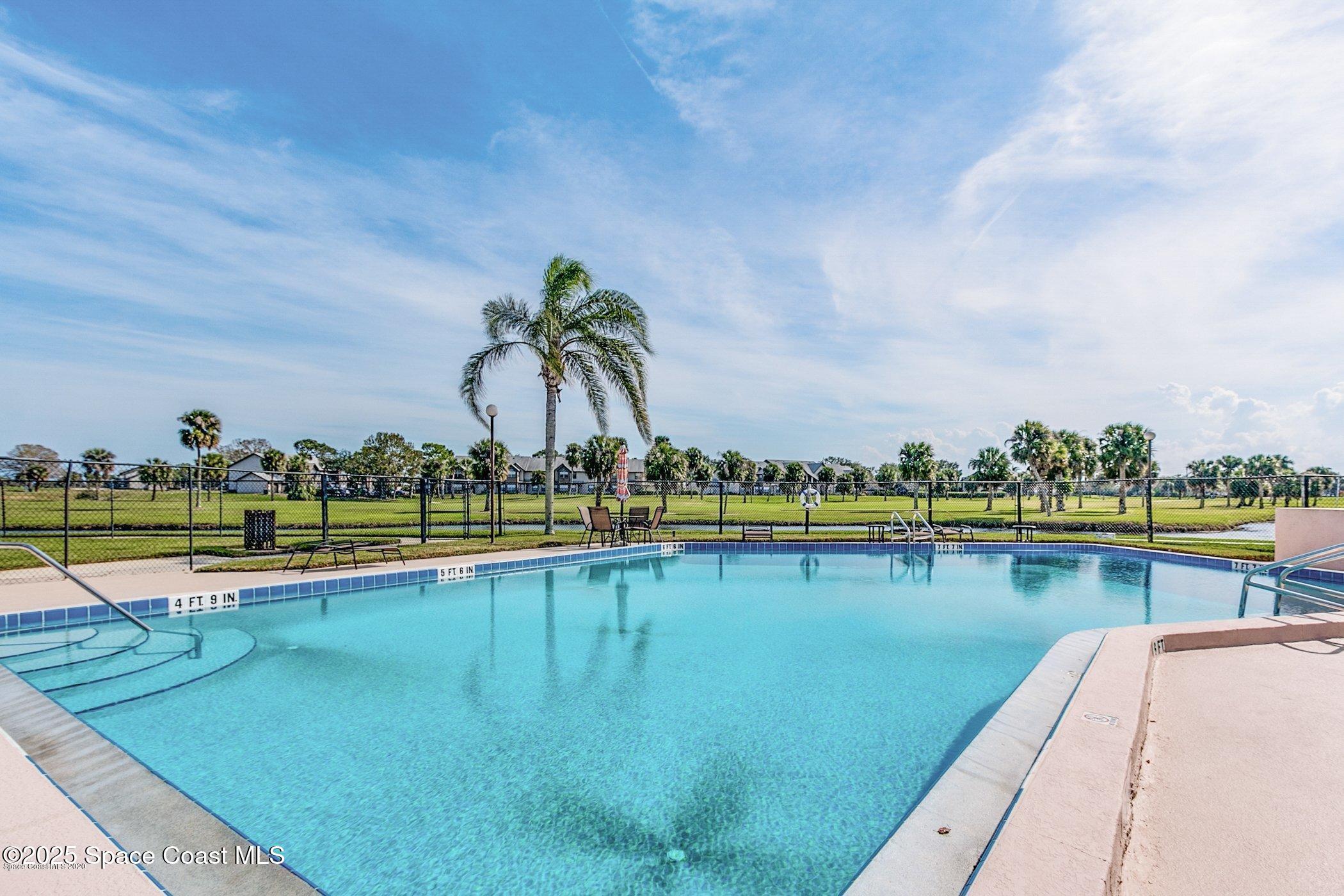 2727 North Wickham Road, Unit 20510 Melbourne, FL 32935 - Photo 23 of 25 a view of a swimming pool and an outdoor seating