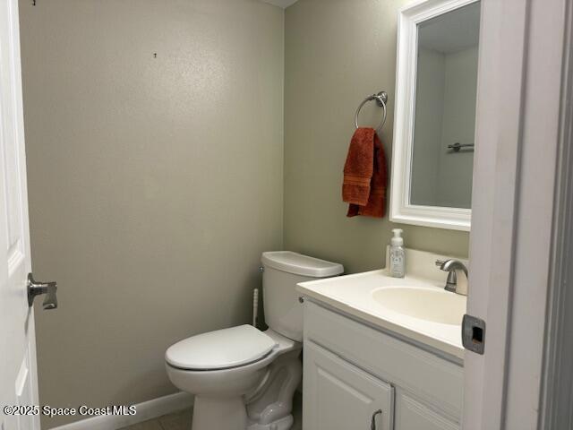 2727 North Wickham Road, Unit 20510 Melbourne, FL 32935 - Photo 7 of 25 a bathroom with a toilet sink and mirror