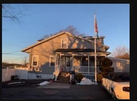 a backyard of a house with table and chairs