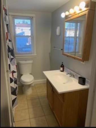 154 River Road, Unit UPPER LEVEL North Arlington, NJ 07031 - Photo 4 of 8 a bathroom with a sink a toilet and mirror