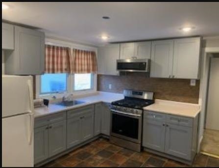 154 River Road, Unit UPPER LEVEL North Arlington, NJ 07031 - Photo 6 of 8 a kitchen with stainless steel appliances granite countertop a sink stove and refrigerator