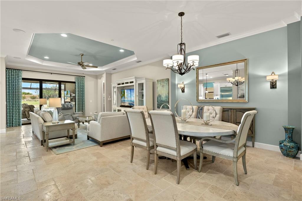 10234 Coconut Road Estero, FL 34135 - Photo 11 of 36 a dining room with furniture a chandelier and window