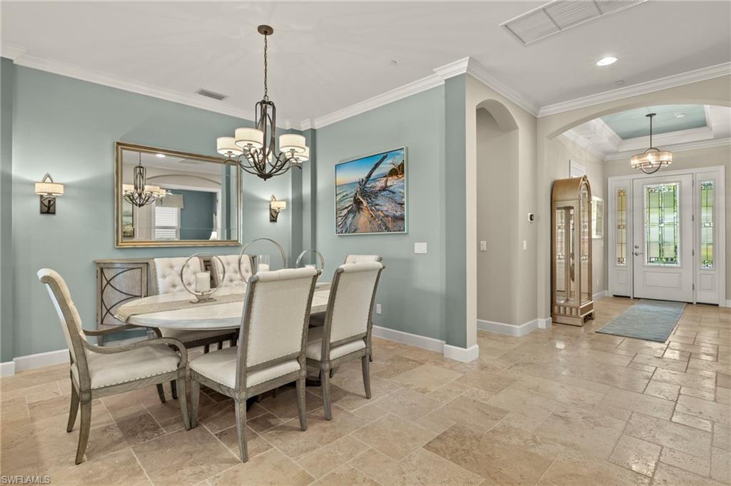 10234 Coconut Road Estero, FL 34135 - Photo 12 of 36 a dining room with furniture a chandelier and window