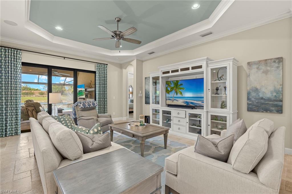 10234 Coconut Road Estero, FL 34135 - Photo 13 of 36 a living room with furniture and a flat screen tv
