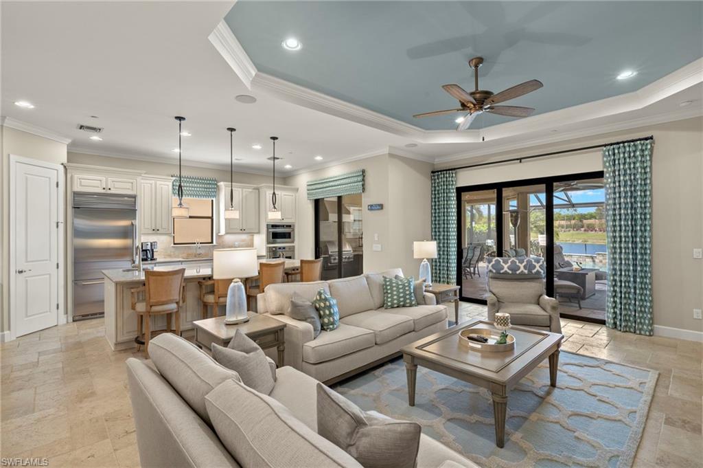 10234 Coconut Road Estero, FL 34135 - Photo 14 of 36 a living room with furniture ceiling fan and a large window