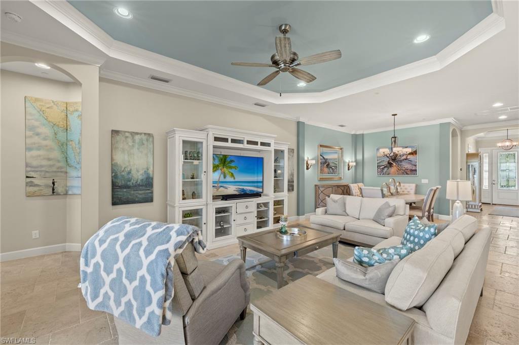 10234 Coconut Road Estero, FL 34135 - Photo 15 of 36 a living room with furniture a flat screen tv and a large window