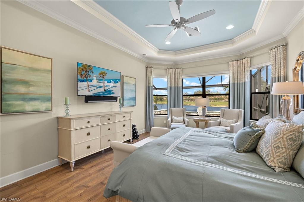 10234 Coconut Road Estero, FL 34135 - Photo 17 of 36 a bedroom with a bed a flat screen tv and dresser