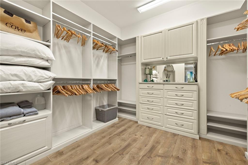 10234 Coconut Road Estero, FL 34135 - Photo 21 of 36 a view of walk in closet with clothes and shoes