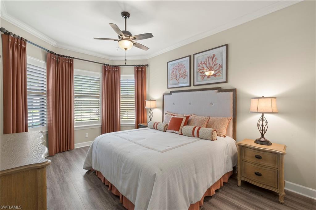 10234 Coconut Road Estero, FL 34135 - Photo 22 of 36 a bedroom with a bed and a chandelier