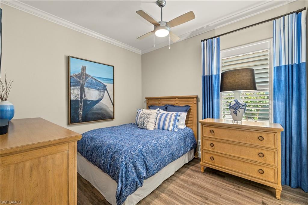 10234 Coconut Road Estero, FL 34135 - Photo 24 of 36 a bedroom with a bed and a dresser