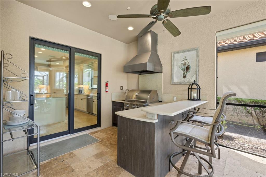 10234 Coconut Road Estero, FL 34135 - Photo 30 of 36 a kitchen with stainless steel appliances granite countertop a sink a stove and a refrigerator