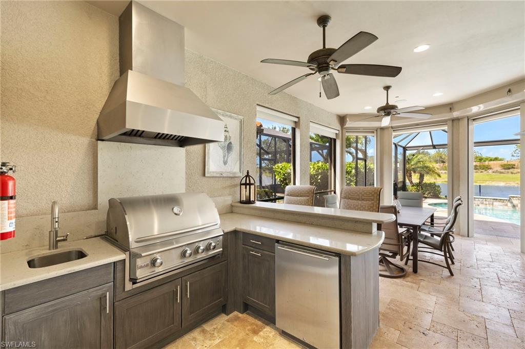 10234 Coconut Road Estero, FL 34135 - Photo 31 of 36 a kitchen with cabinets a sink and appliances