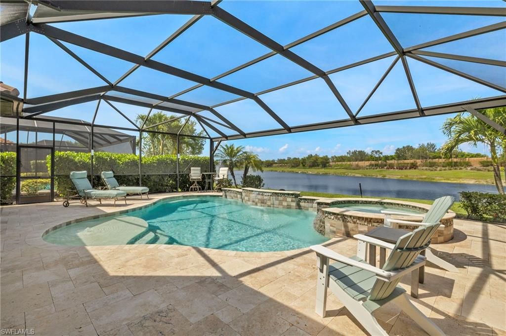 10234 Coconut Road Estero, FL 34135 - Photo 34 of 36 a view of a patio with a table and chairs under an umbrella