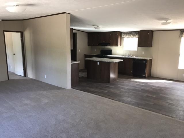 1514 Trotter Way Baker, FL 32531 - Photo 5 of 8 a kitchen with a refrigerator and a sink