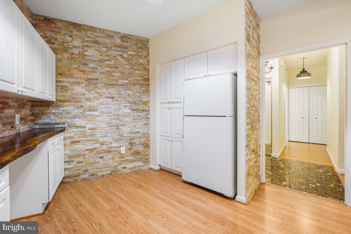 3100 North Leisure World Boulevard, Unit 603 Silver Spring, MD 20906 - Photo 11 of 49 a view of a kitchen with wooden floor and a sink