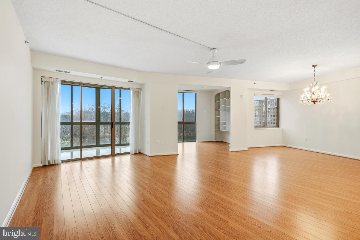 3100 North Leisure World Boulevard, Unit 603 Silver Spring, MD 20906 - Photo 14 of 49 a view of an empty room with wooden floor and a window