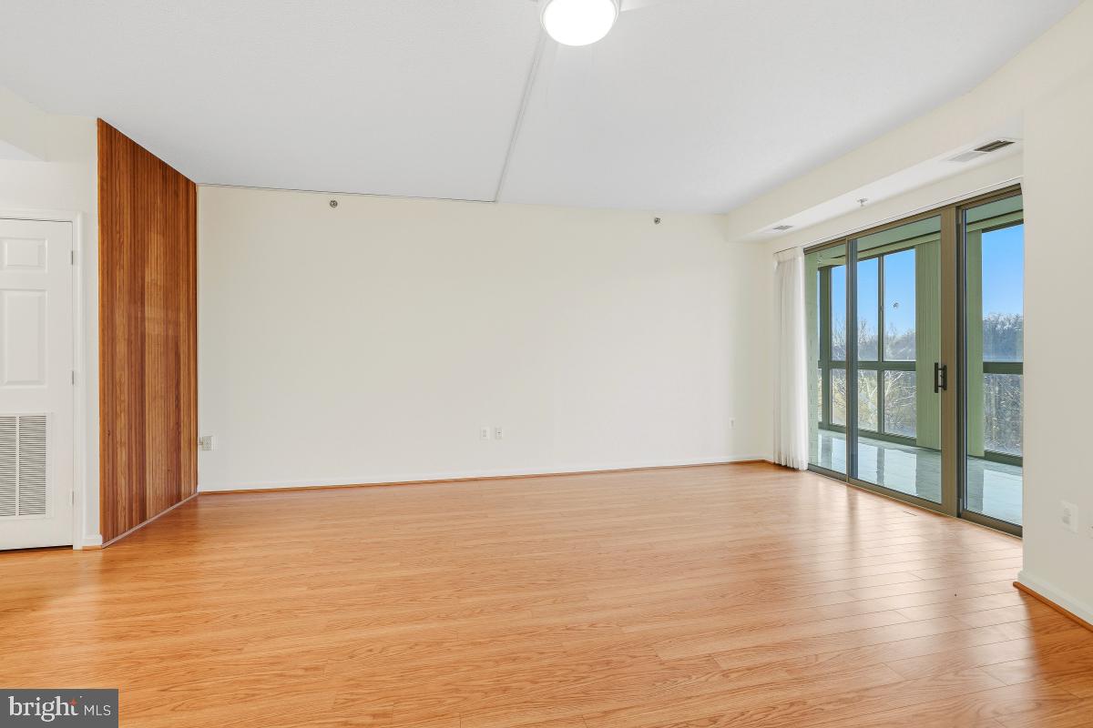 3100 North Leisure World Boulevard, Unit 603 Silver Spring, MD 20906 - Photo 16 of 49 a view of an empty room with wooden floor and a window