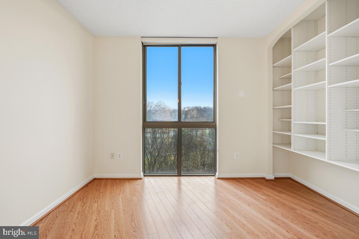 3100 North Leisure World Boulevard, Unit 603 Silver Spring, MD 20906 - Photo 17 of 49 a view of an empty room with wooden floor and a window
