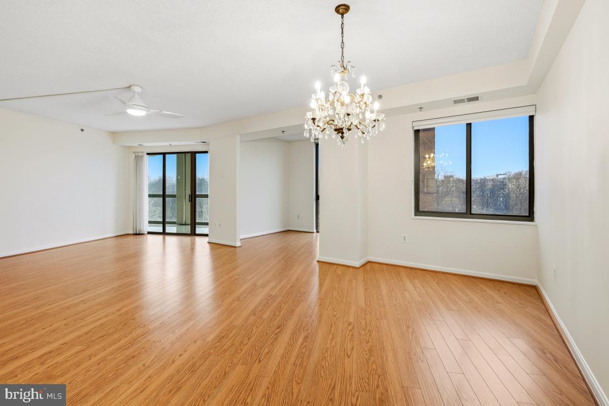 3100 North Leisure World Boulevard, Unit 603 Silver Spring, MD 20906 - Photo 18 of 49 a view of an empty room with chandelier and wooden floor