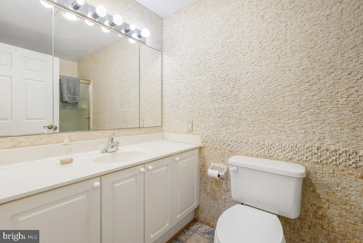 3100 North Leisure World Boulevard, Unit 603 Silver Spring, MD 20906 - Photo 23 of 49 a bathroom with a toilet sink and mirror