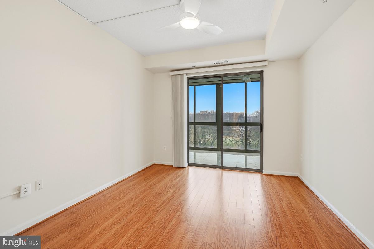 3100 North Leisure World Boulevard, Unit 603 Silver Spring, MD 20906 - Photo 26 of 49 an empty room with wooden floor and windows