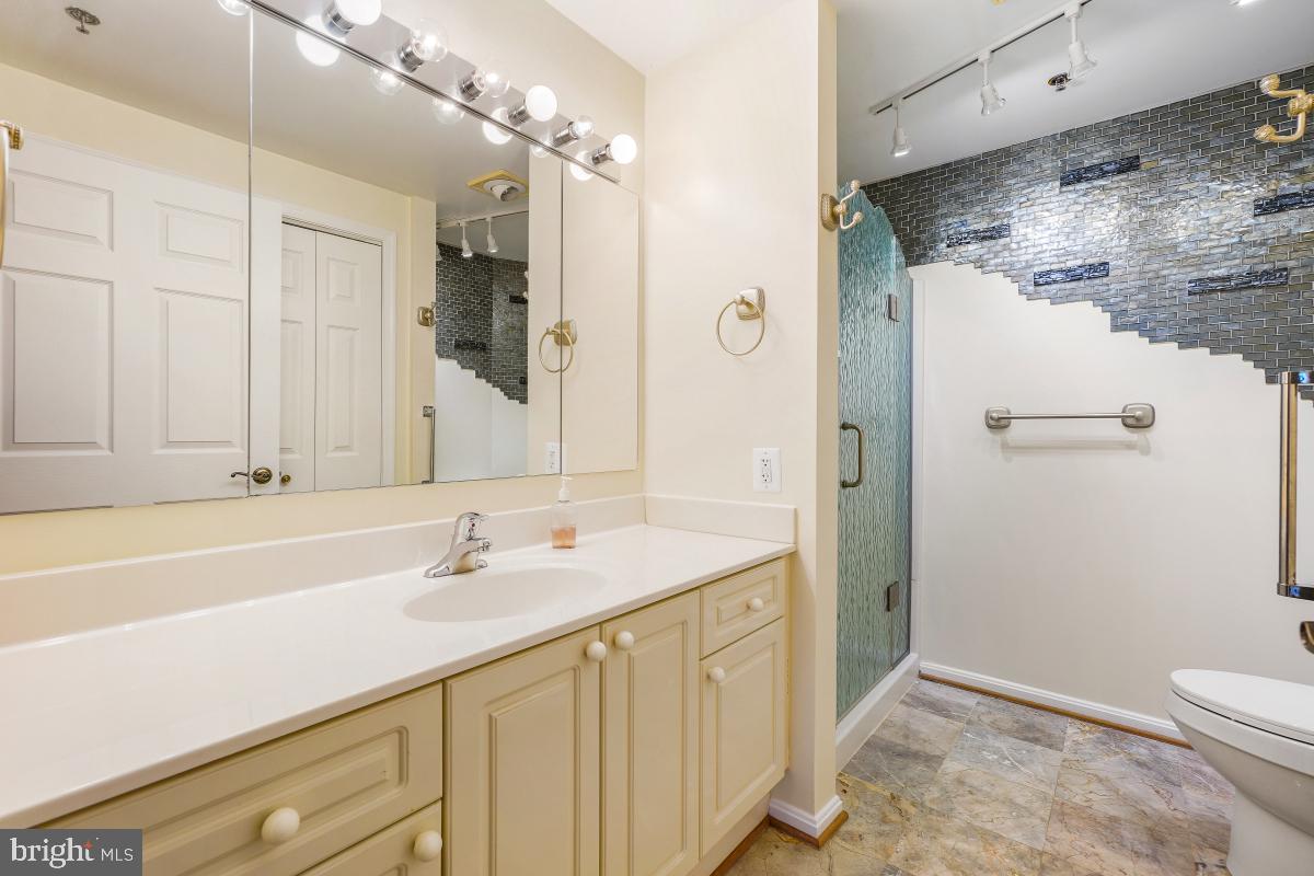 3100 North Leisure World Boulevard, Unit 603 Silver Spring, MD 20906 - Photo 27 of 49 a bathroom with a sink and a mirror