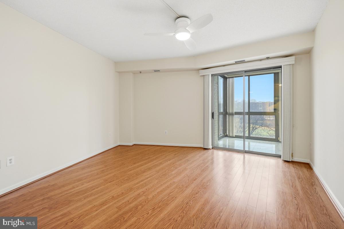 3100 North Leisure World Boulevard, Unit 603 Silver Spring, MD 20906 - Photo 29 of 49 an empty room with wooden floor and windows