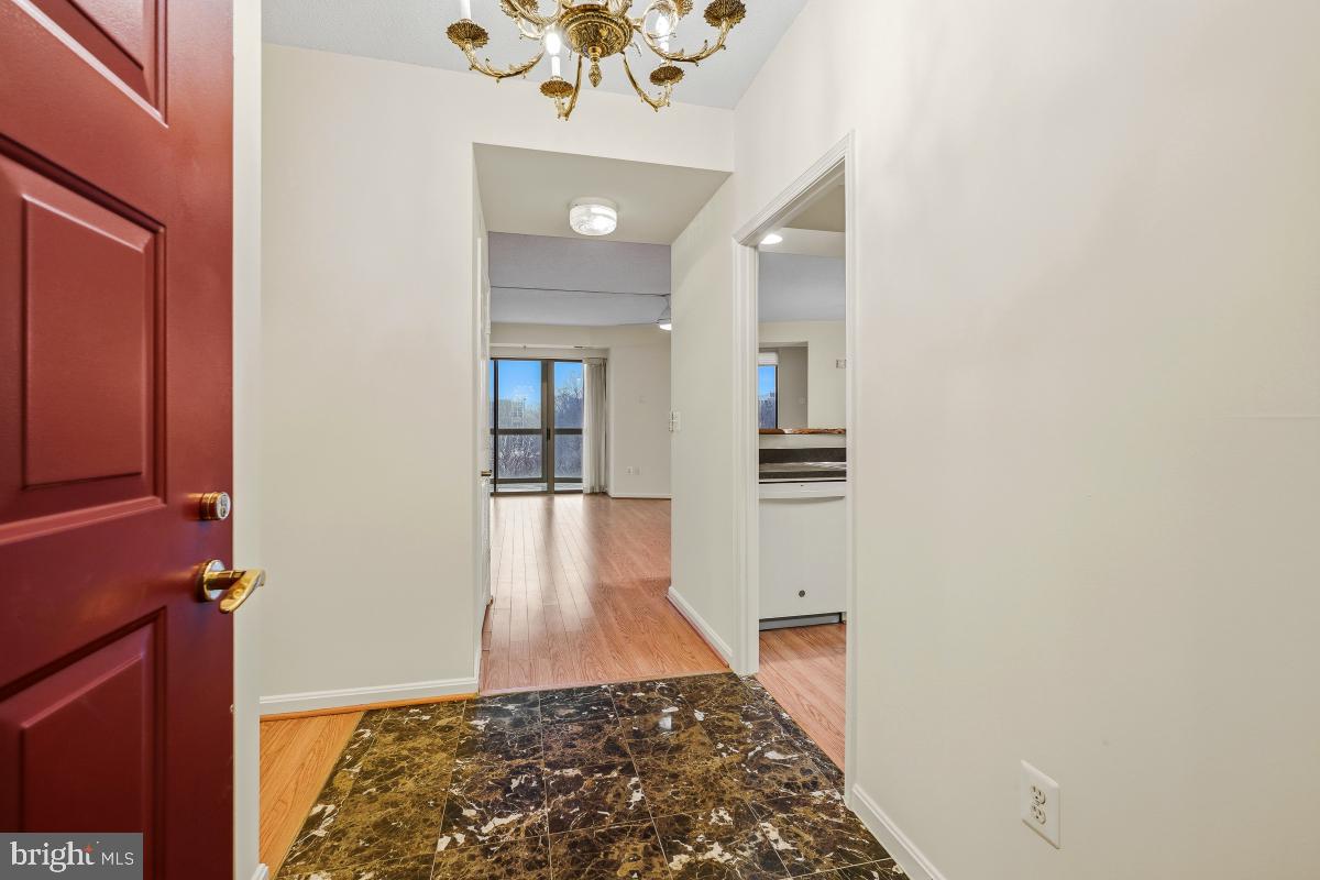 3100 North Leisure World Boulevard, Unit 603 Silver Spring, MD 20906 - Photo 8 of 49 a view of a hallway with wooden floor and staircase