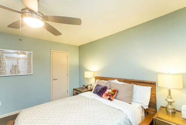 a bedroom with a bed and window