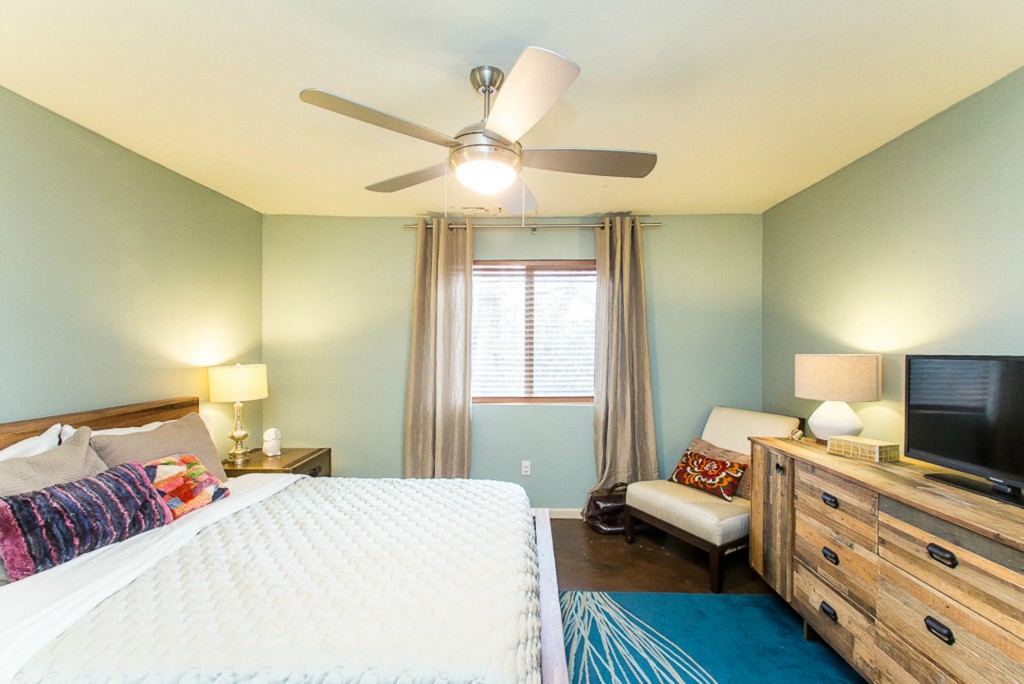 41 Waller Street, Unit 308 Austin, TX 78702 - Photo 19 of 34 a bedroom with a bed and wooden floor