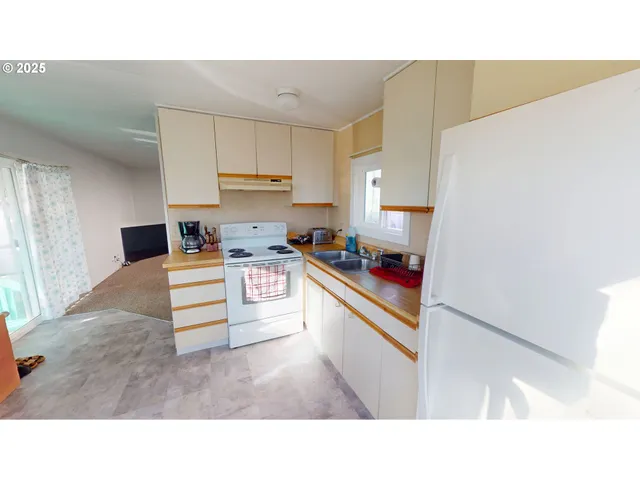 a kitchen with stainless steel appliances kitchen island sink refrigerator and stove