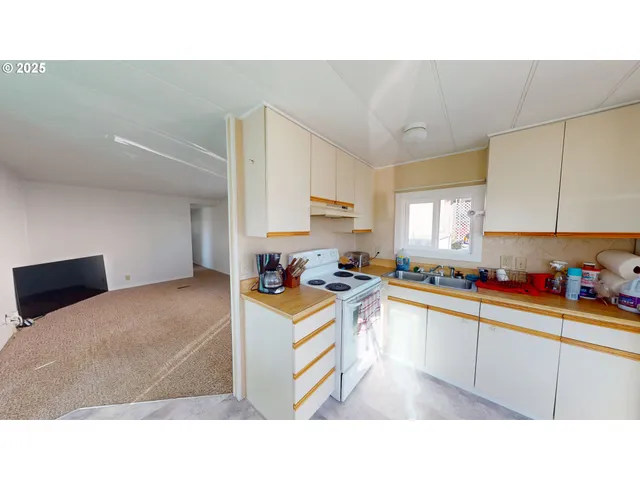 a kitchen with a sink a stove and cabinets