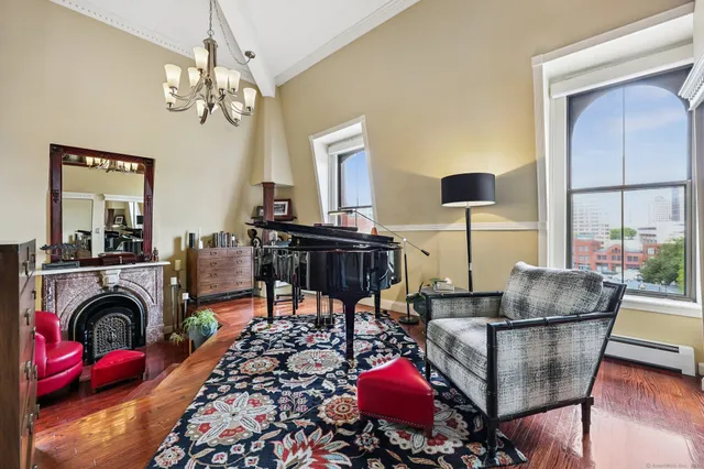 a living room with furniture a fireplace and a chandelier