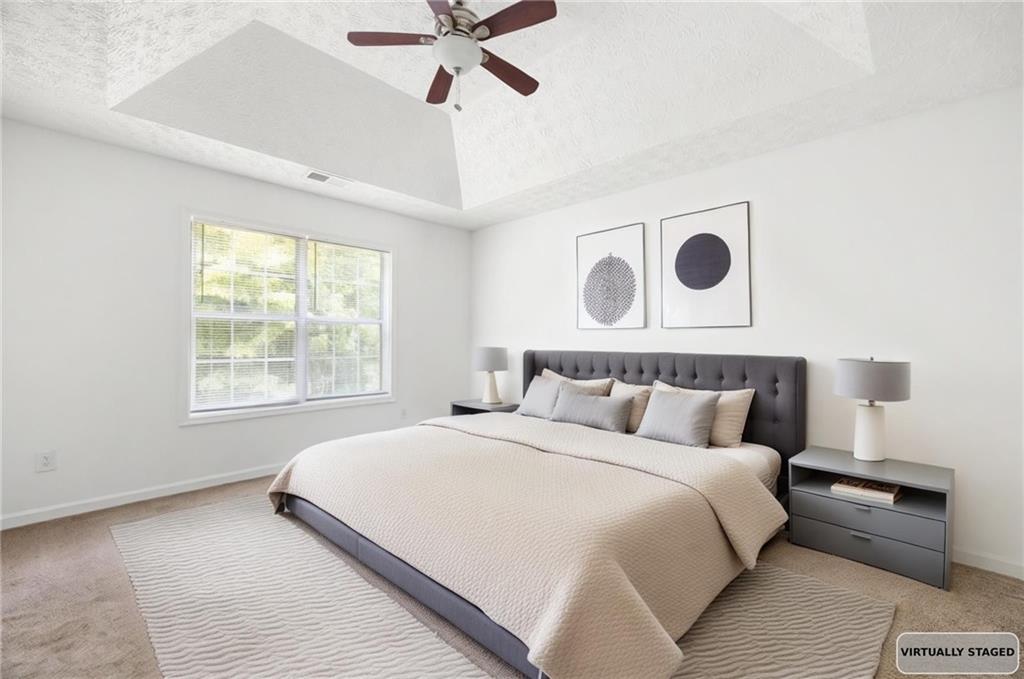 1093 Athena Court Acworth, GA 30101 - Photo 12 of 27 a bedroom with a large bed and a window