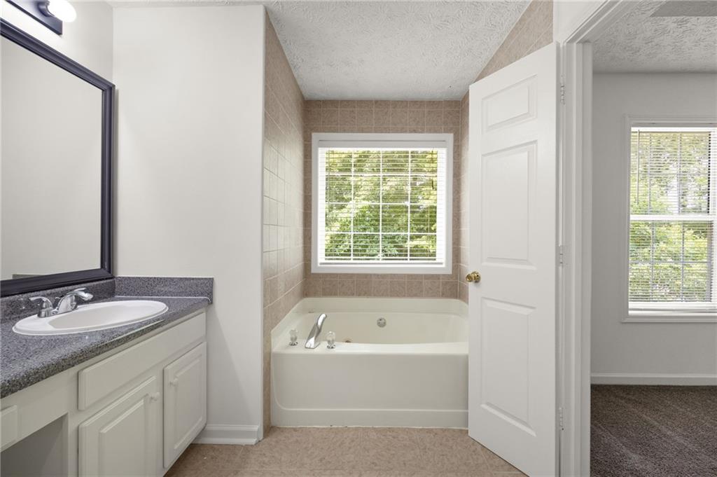 1093 Athena Court Acworth, GA 30101 - Photo 13 of 27 a bathroom with a bathtub and a sink