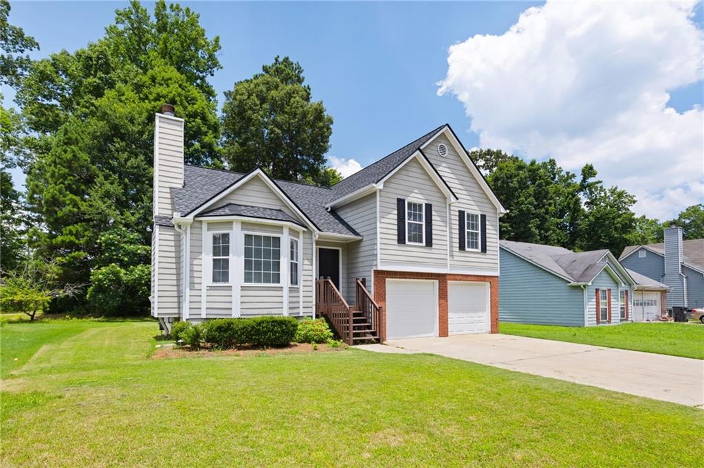 1093 Athena Court Acworth, GA 30101 - Photo 2 of 27 a front view of a house with a yard and garage