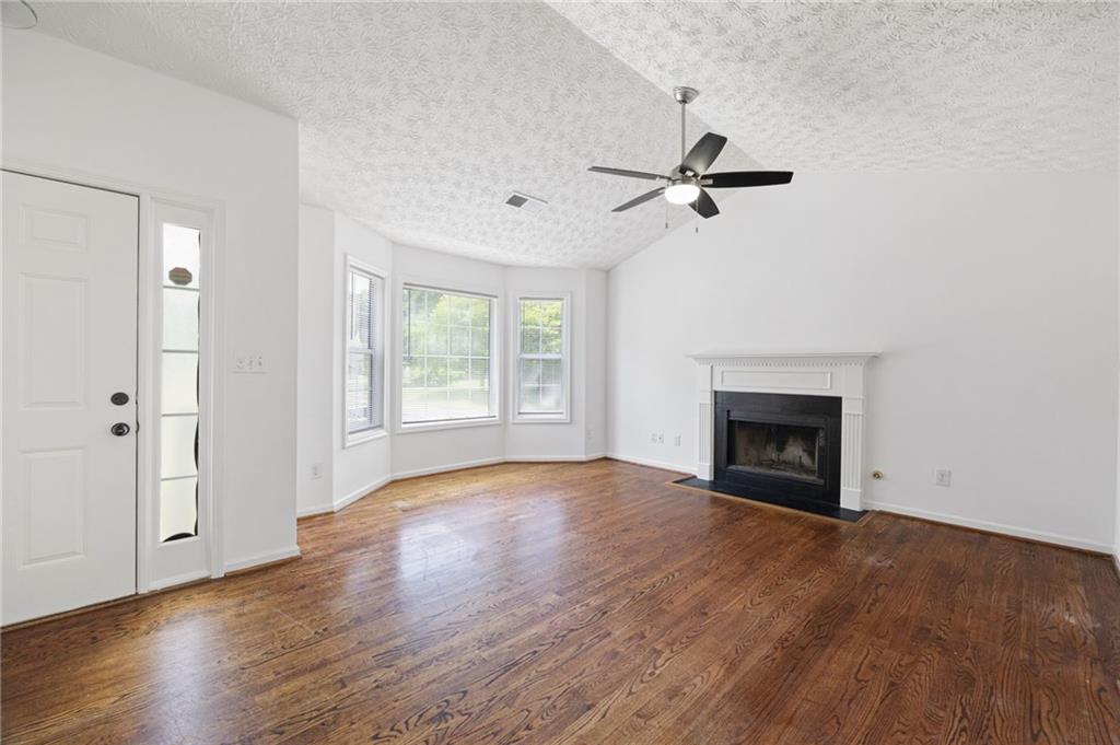 1093 Athena Court Acworth, GA 30101 - Photo 4 of 27 an empty room with windows fireplace and a sink