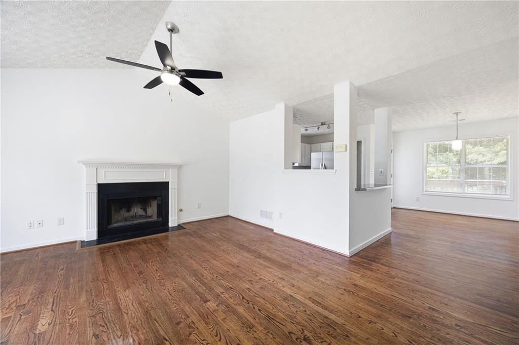 1093 Athena Court Acworth, GA 30101 - Photo 6 of 27 an empty room with windows and fireplace