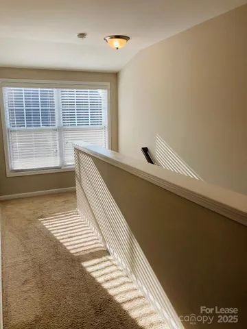 a view of a room with wooden floor and a window