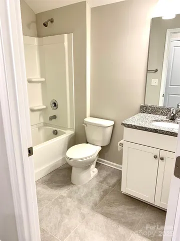 a white toilet sitting next to a bathroom sink