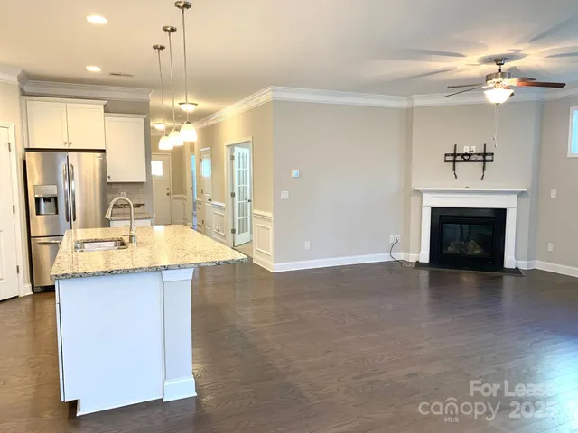 a kitchen with kitchen island a sink stainless steel appliances and cabinets
