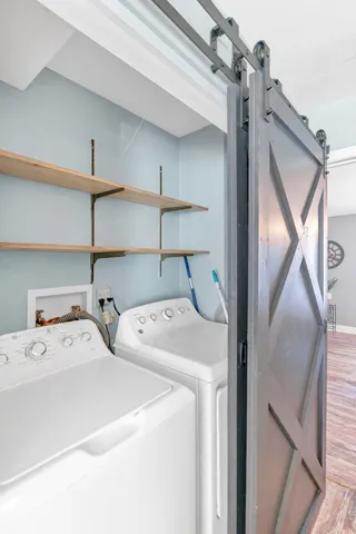 a view of livingroom and dining room with furniture wooden floor a chandelier