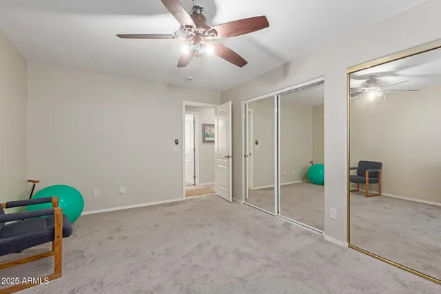 a bedroom with bed and painting on the wall