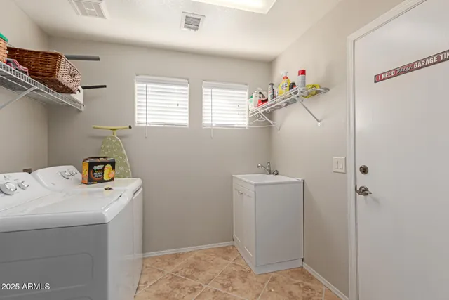 a room with furniture a bookshelf and a window