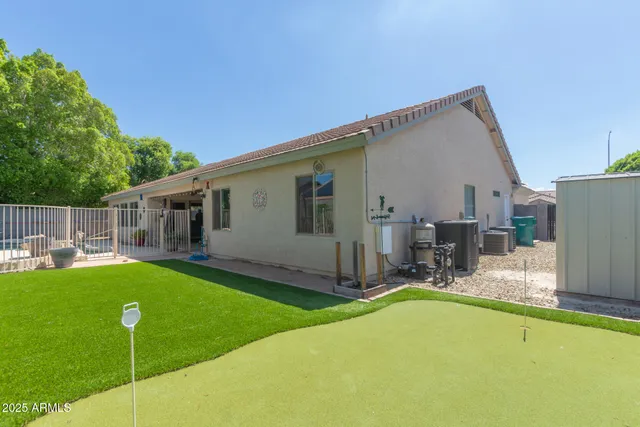 a backyard of a house with table and chairs