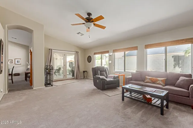 a bedroom with furniture and large windows
