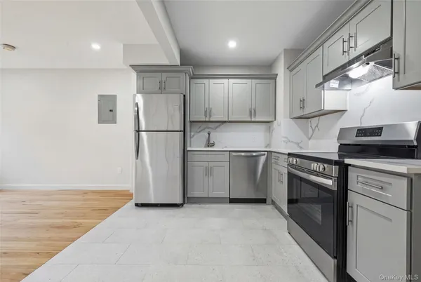 a kitchen with a sink refrigerator and cabinets