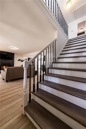 a view of dining room with wooden floor and stairs