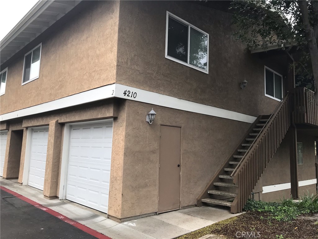 4210 Fiesta Way, Unit 4 Oceanside, CA 92057 - Photo 1 of 1 a view of an entryway with staircase